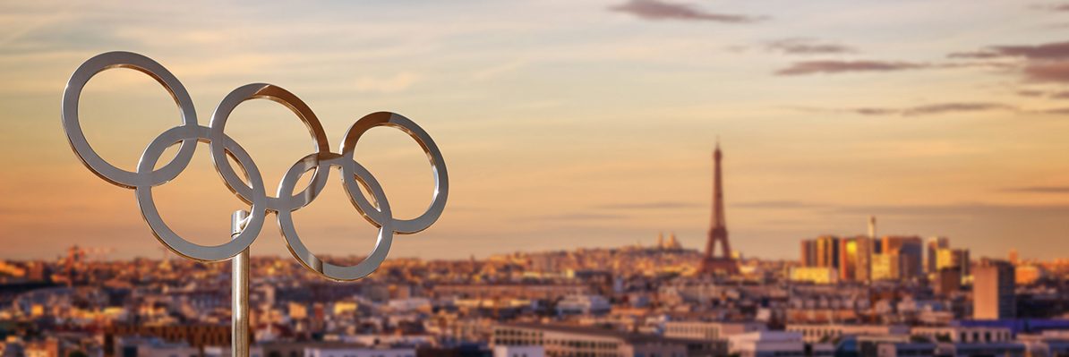 Olympic rings  at sunset with the Eiffel tower in Paris France panoramic background, Paris 2024 summer olympic games web banner