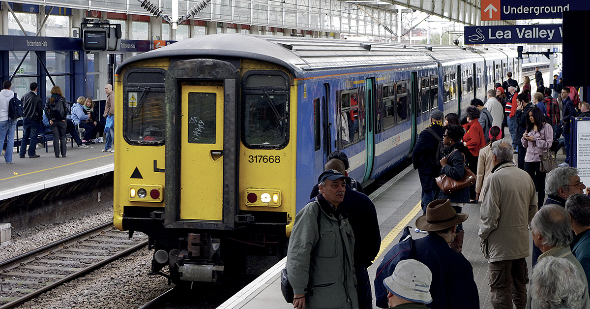 De nombreux voyageurs sur un quai en gare de Tottenham Hale en Angleterre.