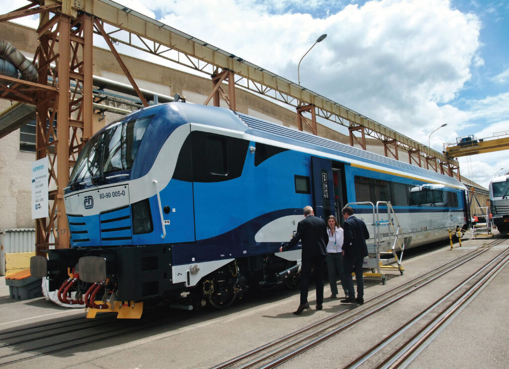 a group of people standing next to a train